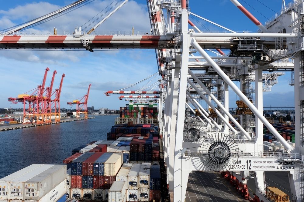 Melbourne, Australia 05 08 2025The container ship during cargo operation loading and discharging by gantry cranes operated by stevedores moored in port of Melbourne, Australia.
